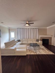 a living room with a white couch and a fireplace at 5bd Beautiful Modern home in Spring in Spring