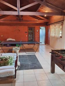 a living room with a ping pong table and a ping pong table at Sítio Ubaitaba in Boituva