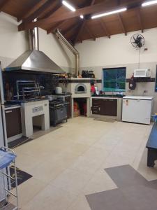 a large kitchen with a stove and appliances in it at Sítio Ubaitaba in Boituva