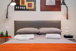 a bedroom with a bed with two pillows on it at JDN Rooms in San Donato Milanese