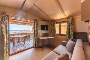 a living room with a couch and a view of the ocean at Kon Tiki in Saint-Tropez