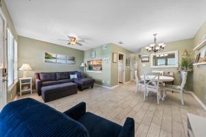 a living room with a couch and a table at Sea Breeze 316 by Vacation Homes Collection in Gulf Shores