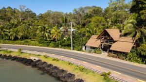 a house on the side of a road next to a river at Somewhere In Bocas in Bocas Town