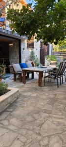a picnic table and chairs on a patio at The Zephyr House -2- in Pyrgos