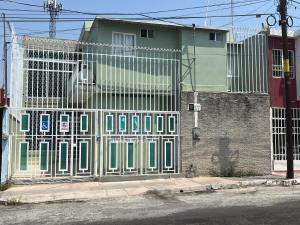 a gate on the side of a building at CASA DE LA ABUELa in Colima