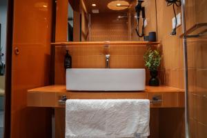 a bathroom with a sink and a white towel at JDN Rooms in San Donato Milanese