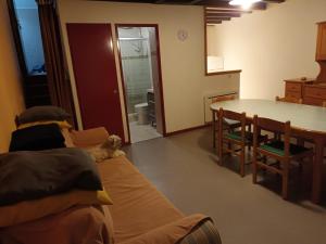 a living room with a couch and a table at Maison dans un chalet en bordure de lac in Loudenvielle