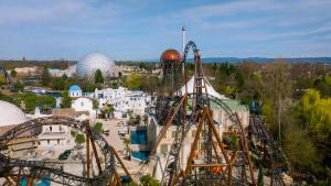 an amusement park with roller coasters and rides at La parenthèse in Artolsheim