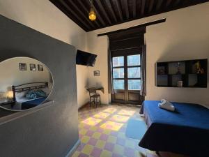a bedroom with a blue bed and a mirror at Hotel Zamora Downtown CDMX in Mexico City
