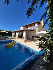 a swimming pool with two rubber ducks in the water at Villa Susann in Šibenik