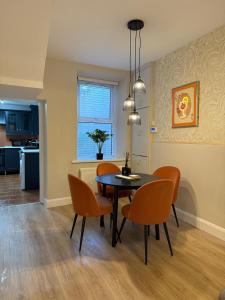 a dining room with a table and chairs at Derry City Centre Townhouse in Derry Londonderry