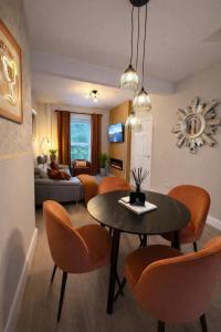 a living room with a table and chairs and a couch at Derry City Centre Townhouse in Derry Londonderry