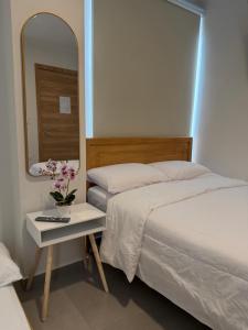 a bedroom with a bed and a table with a mirror at Suite For You - Salinas Chipipe in Salinas