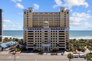 a large hotel with the ocean in the background at Camelot by the Sea Oceanfront 2BR in Myrtle Beach +54 photos