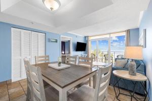 a dining room with a table and chairs and a couch at Camelot by the Sea Oceanfront 2BR in Myrtle Beach