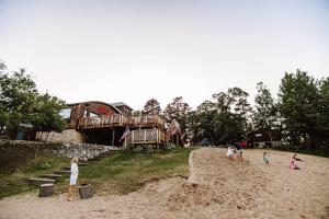 a group of children playing in the sand on a beach at Bootleggers Lodge on Lake Nokomis in Tomahawk