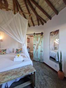 a bedroom with a bed and a mirror at Vila Cacau pousada - Serra Grande in Serra Grande