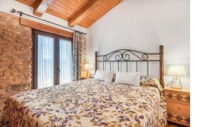 a bedroom with a bed and a large window at Casa rural LA PEDANIA in El Salse +23 photos