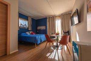 a bedroom with a bed and a table and chairs at B&B Sentiero Rusca in Sondrio