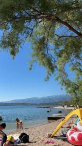 a group of people on a beach with a tent at House Calmaria in Novigrad Dalmatia