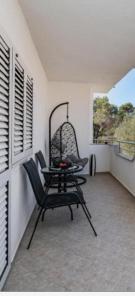 a chair and a table on a balcony at House Calmaria in Novigrad Dalmatia +12 photos
