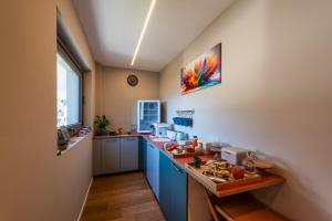 a kitchen with blue cabinets and a counter top at B&B Sentiero Rusca in Sondrio