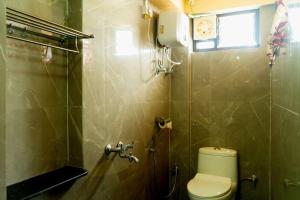 a small bathroom with a toilet and a window at Bethany Homestay in Kalimpong +40 photos