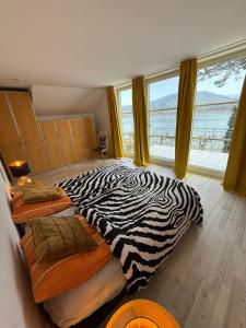 a zebra print bed in a room with a large window at Viktoria`s Penthouse in Bad Breisig