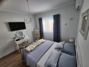 a bedroom with a bed and a desk with a television at Villa Susann in Šibenik +59 photos