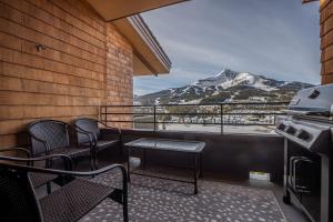 a balcony with chairs and a view of a mountain at North Summit in Big Sky