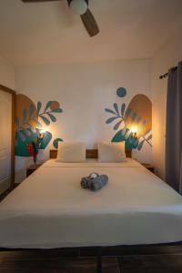 a bedroom with a bed with a pair of shoes on it at Somewhere In Bocas in Bocas Town +20 photos