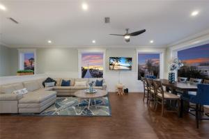 a living room with a couch and a table at LUXURY VACATION HOME! ADD A GOLF CART!! in Bradenton Beach