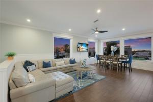 a living room with a couch and a dining room at LUXURY VACATION HOME! ADD A GOLF CART!! in Bradenton Beach