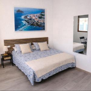a bedroom with a bed and a view of a island at Alma Del Sur Tenerife in Arona
