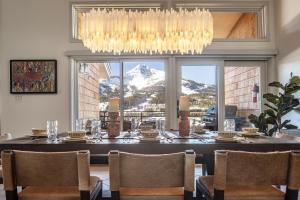 a dining room with a table and a chandelier at North Summit in Big Sky
