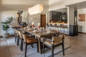 a dining room with a long table and chairs at North Summit in Big Sky