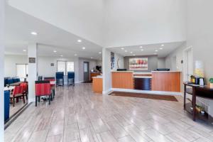 a large lobby with tables and chairs in a building at Antioch Inn and Suites in Antioch