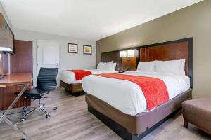 a hotel room with two beds and a desk at Antioch Inn and Suites in Antioch