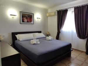 a bedroom with a bed with two towels on it at Casa Luna Llena in Calpe +63 photos