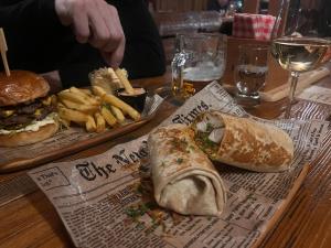 a table topped with a sandwich and french fries at Žilina in Čadca