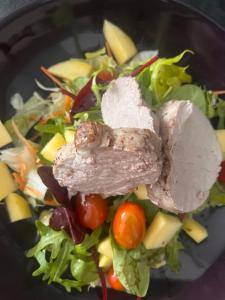a salad with meat and vegetables on a plate at Žilina in Čadca