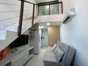 a living room with a couch and a staircase at Sunny Hall by AFT in Porto De Galinhas
