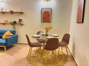 a dining room with a table and chairs at Bohemian & White Getaway Zone4 in Abidjan