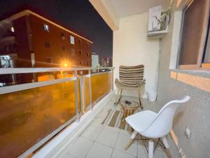 a balcony with two chairs and a table at Bohemian & White Getaway Zone4 in Abidjan
