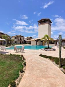 a swimming pool in front of a house at Kite House Lençóis II in Santo Amaro