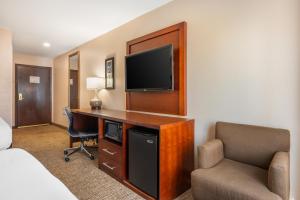 a hotel room with a desk with a television and a chair at Comfort Inn Lafayette I-65 in Lafayette