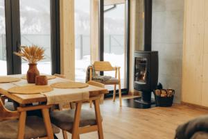a room with a table and a wood stove at Zarichna Cottage in Podgorodtsy +13 photos