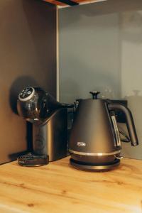a tea kettle sitting on top of a table at Zarichna Cottage in Podgorodtsy