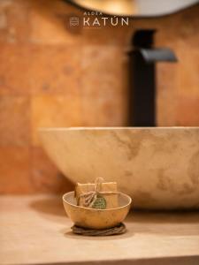 a bowl sitting on top of a table next to a bowl at Hotel Aldea Katún in Izamal +36 photos