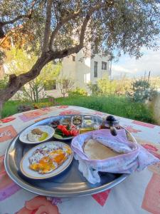 a table with a tray of food on it at Mountain Pad Overlooking Jerash - HQ Budget stay in Jerash